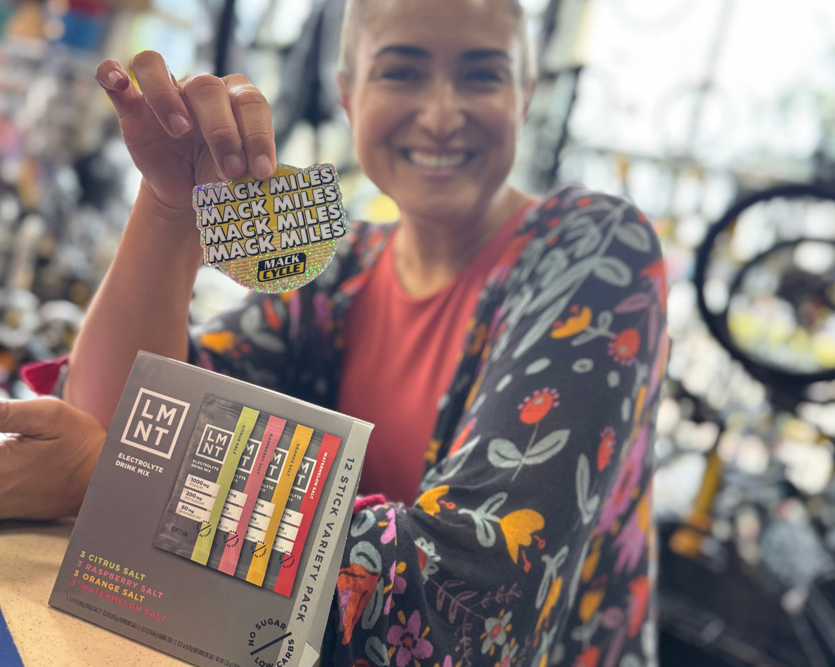 VALERIA RODRIGUEZ PICKING UP HER MACK MILES STICKER AT MACK CYCLE AS WELL AS HER FREE LMNT 12 STICK VARIETY PACK.