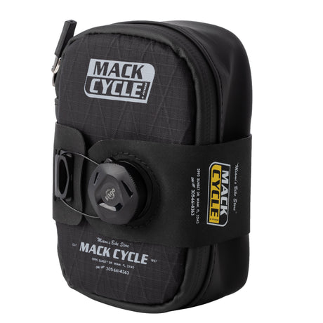 Angled front view showing full mack cycle seat bag profile with branding and dial strap system